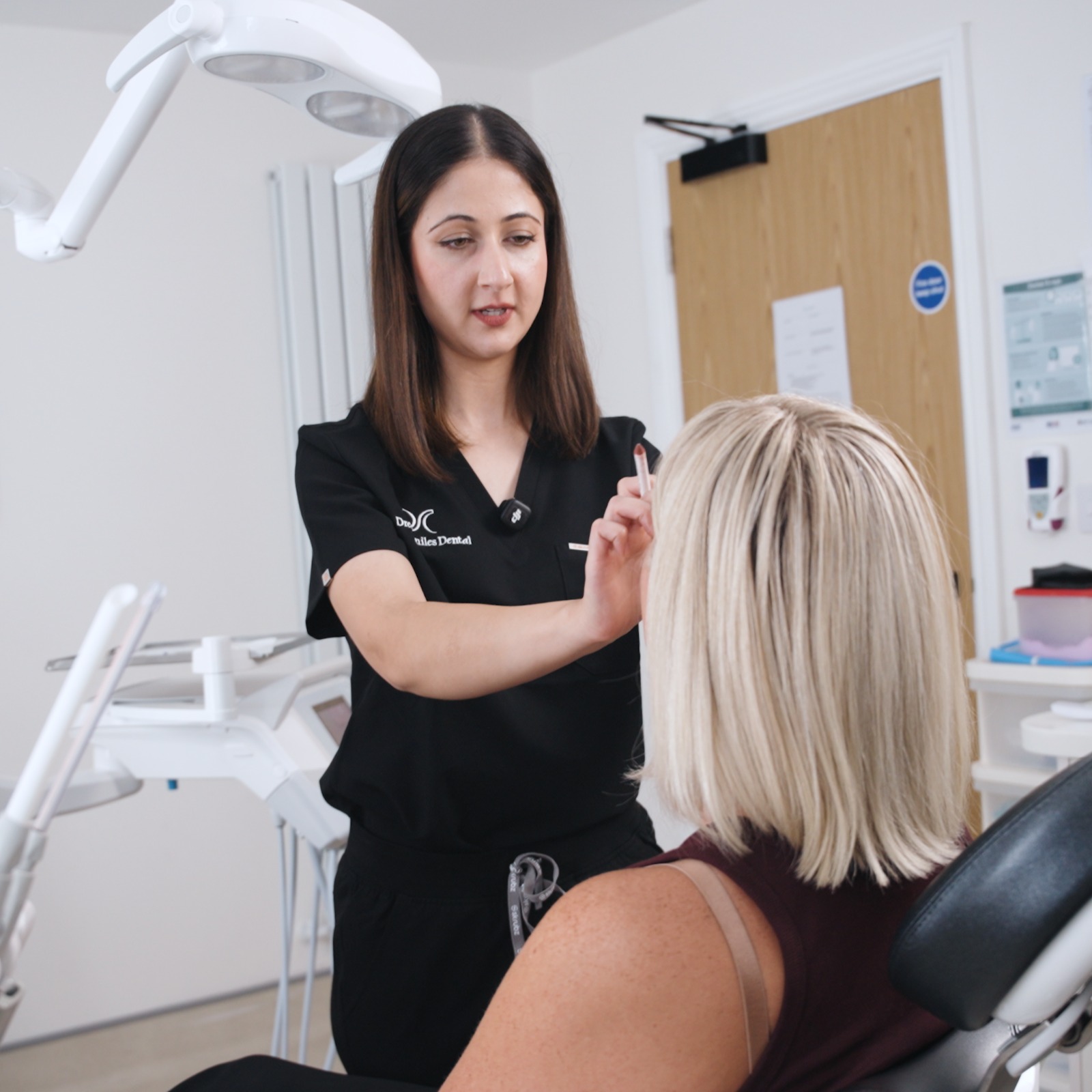 Assessing a patient before treatment at Dream Smiles Dental