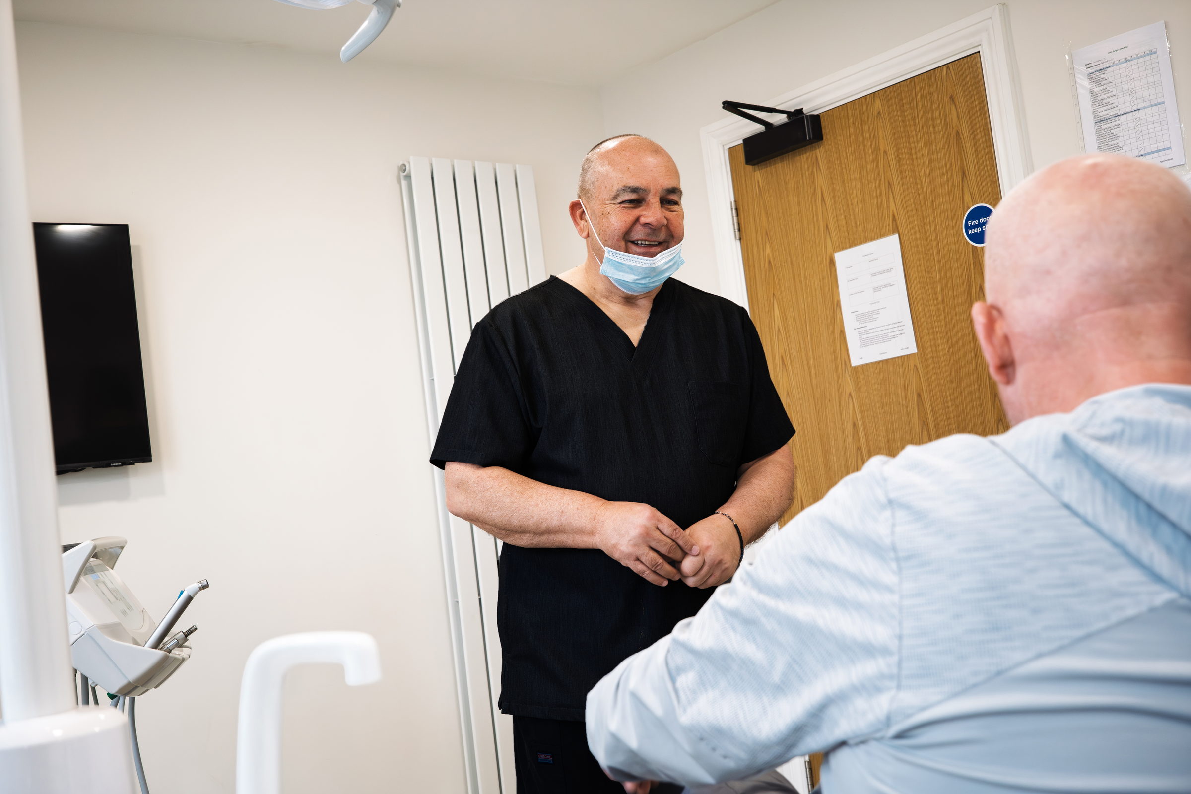 John Wibberley talking with a denture patient at Dream Smiles Dental in Bolton