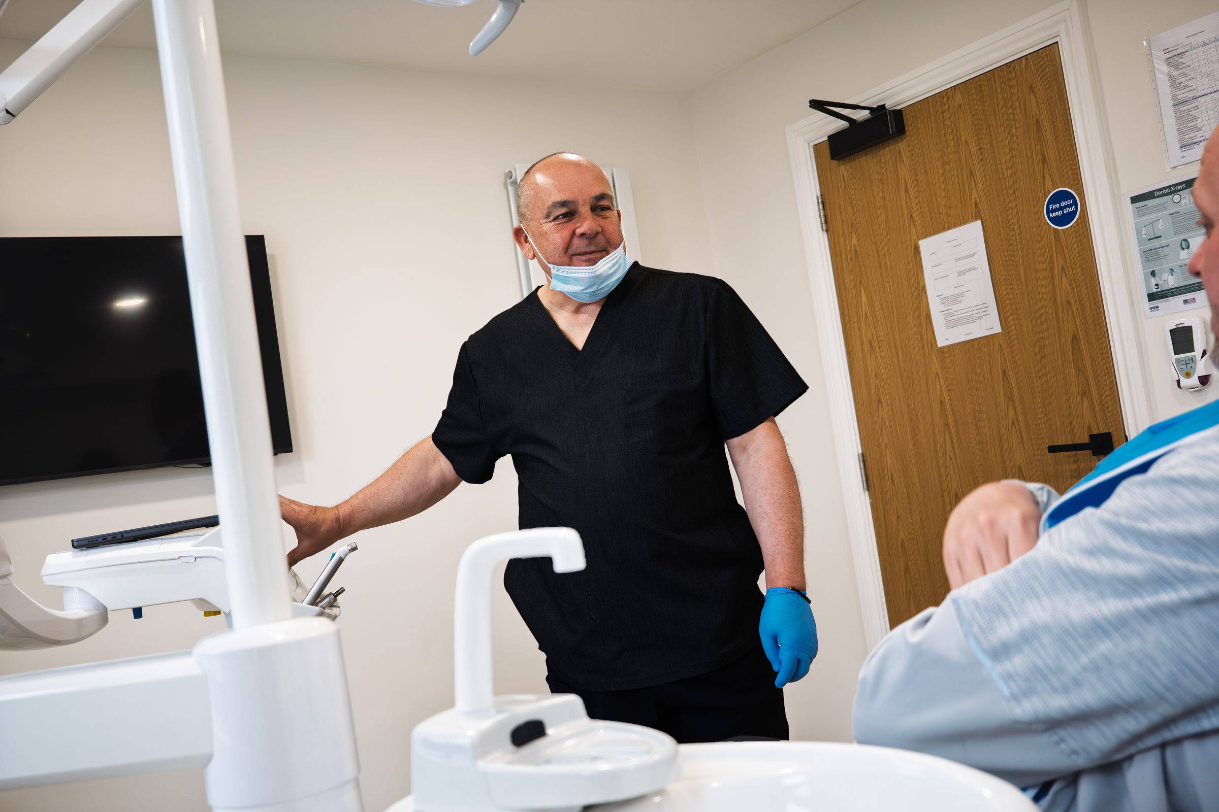 John Wibberley with a denture patient in a treatment room at Dream Smiles Dental in Bolton