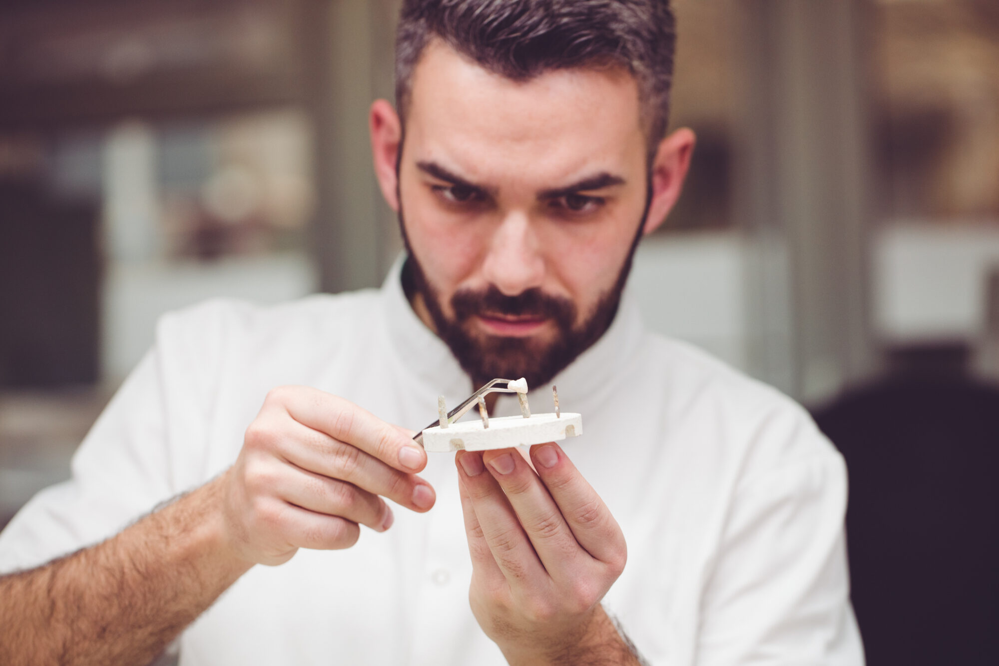 Dental technician crafting porcelain crowns for patients at Dream Smiles Dental