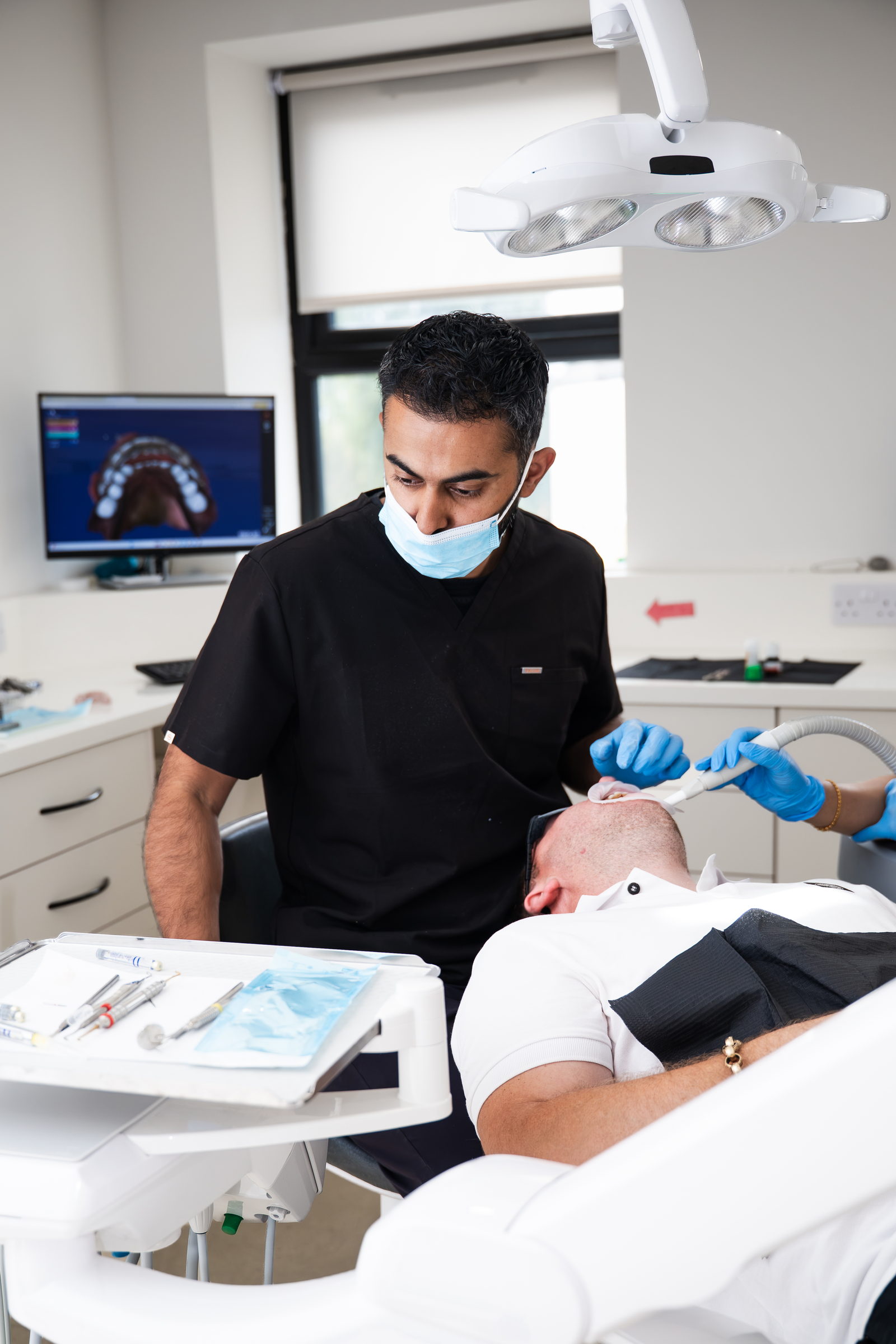 A dentist and nurse treating a patient at Dream Smiles Dental in Bolton